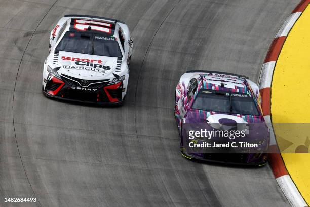 Alex Bowman, driver of the Ally Chevrolet, and Denny Hamlin, driver of the Sport Clips Haircuts Toyota, race during the NASCAR Cup Series NOCO 400 at...