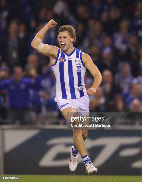 Kieran Harper of the Kangaroos celebrates after kicking a goal during the AFL Rd 16 game between North Melbourne and Carlton at Etihad Stadium on...