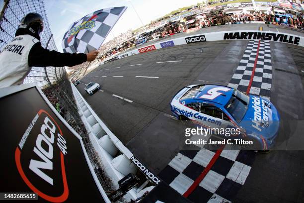 Kyle Larson, driver of the HendrickCars.com Chevrolet, takes the checkered flag to win the NASCAR Cup Series NOCO 400 at Martinsville Speedway on...