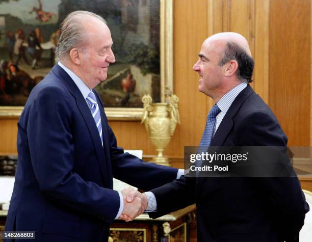 King Juan Carlos of Spain receives the Minister of Economy and Competitiveness Luis de Guindos during a meeting of the council of ministers at the...