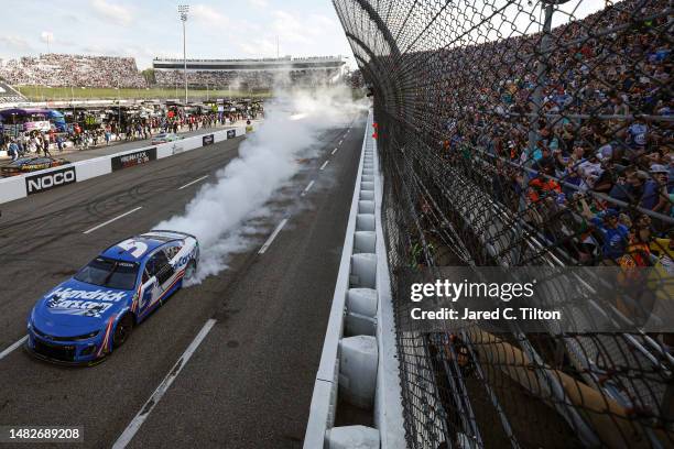 Kyle Larson, driver of the HendrickCars.com Chevrolet, celebrates with a burnout after winning the NASCAR Cup Series NOCO 400 at Martinsville...