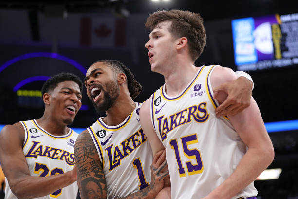 Angelo Russell of the Los Angeles Lakers, Rui Hachimura of the Los Angeles Lakers and Austin Reaves of the Los Angeles Lakers react during the second...