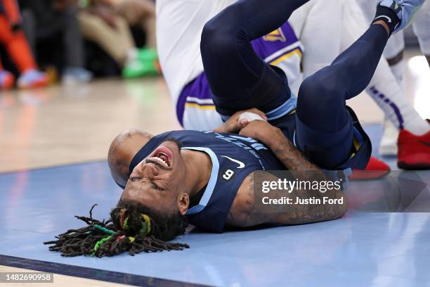 Ja Morant of the Memphis Grizzlies injures his hand during the second half against the Los Angeles Lakers during Game One of the Western Conference...