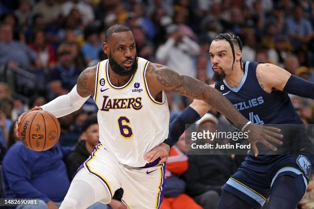 LeBron James of the Los Angeles Lakers handles the ball against Dillon Brooks of the Memphis Grizzlies during the first half of Game One of the...