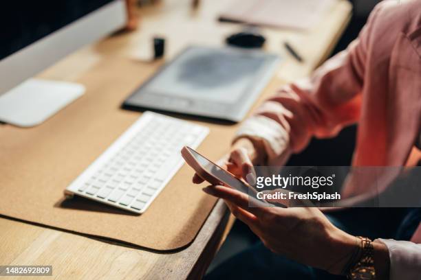 an unrecognizable businesswoman using her mobile phone while working  in the office - finger dialing touch tone telephone stock pictures, royalty-free photos & images