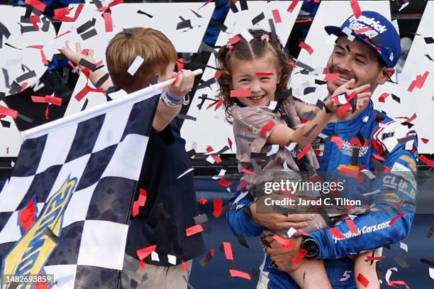 Kyle Larson, driver of the HendrickCars.com Chevrolet, celebrates with son, Owen and daughter Audrey in victory lane after winning the NASCAR Cup...