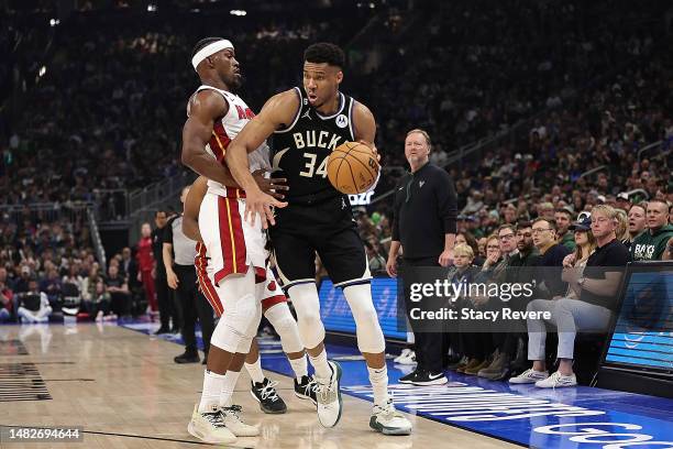 Giannis Antetokounmpo of the Milwaukee Bucks is defended by Jimmy Butler of the Miami Heat during the first half of Game One of the Eastern...