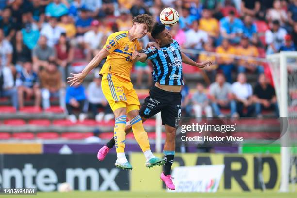 Igor Lichnovsky of Tigres jumps for the ball with Angel Sepulveda of Queretaro during the 15th round match between Querataro and Tigres UANL as part...