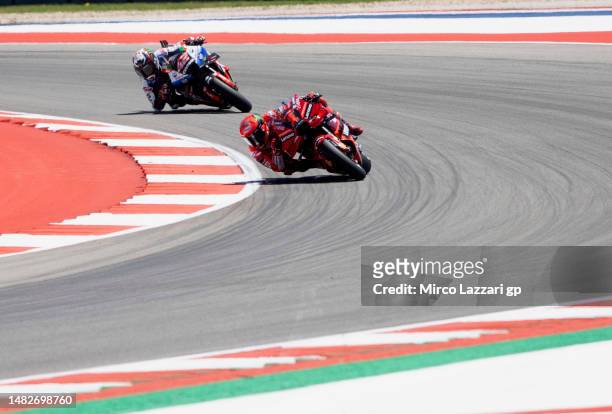 Francesco Bagnaia of Italy and Ducati Lenovo Team leads Alex Rins of Spain and LCR Honda Castrol during the MotoGP race during the MotoGP Of The...