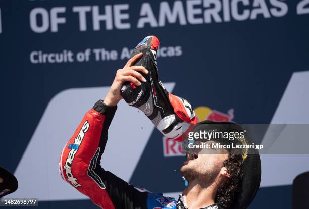 Alex Rins of Spain and LCR Honda Castrol drinks Prosecco and celebrates the victory on the podium at the end of the MotoGP race during the MotoGP Of...