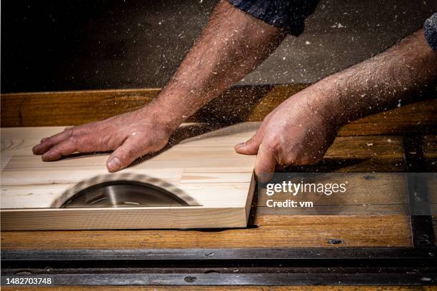 craftsman hands cutting wood with table saw - table saw stock pictures, royalty-free photos & images