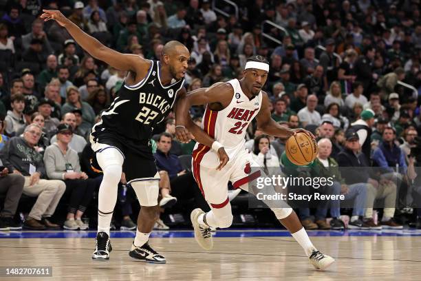 Jimmy Butler of the Miami Heat drives around Khris Middleton of the Milwaukee Bucks during the second half of Game One of the Eastern Conference...