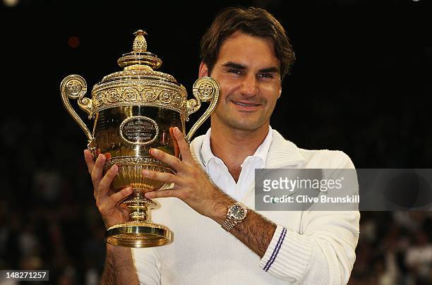 Roger Federer of Switzerland holds up the winner's trophy after winning his Gentlemen's Singles final match against Andy Murray of Great Britain on...