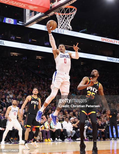 Russell Westbrook of the LA Clippers lays up a shot past Kevin Durant of the Phoenix Suns during the first half Game One of the Western Conference...