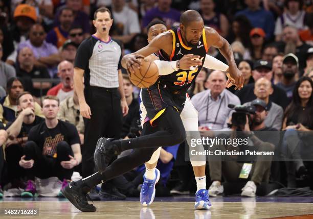 Kevin Durant of the Phoenix Suns drives the ball past Russell Westbrook of the LA Clippers during the first half Game One of the Western Conference...