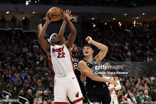 Jimmy Butler of the Miami Heat drives to the basket against Khris Middleton and Grayson Allen of the Milwaukee Bucks during the second half of Game...