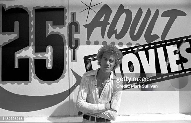 Porn Actor John Holmes poses in front of adult movie theatre in Hollywood, CA 1975.
