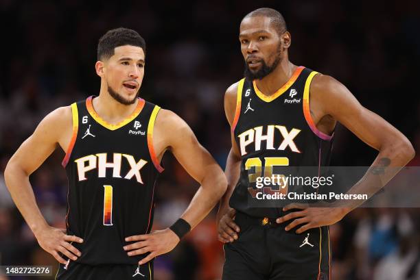 Devin Booker and Kevin Durant of the Phoenix Suns talk during the second half Game One of the Western Conference First Round Playoffs at Footprint...