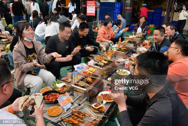 Diners enjoy a barbecue feast at a restaurant on March 31, 2023 in Zibo, Shandong Province of China.