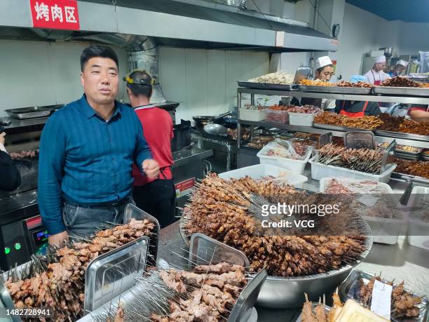 Staff members work at a kitchen of a popular barbecue restaurant on March 31, 2023 in Zibo, Shandong Province of China.