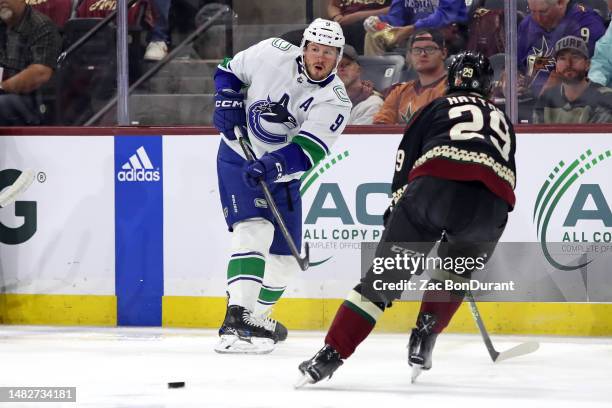 Miller of the Vancouver Canucks makes a pass against Barrett Hayton of the Arizona Coyotes at Mullett Arena on April 13, 2023 in Tempe, Arizona.