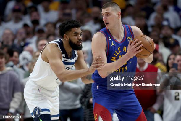 Nikola Jokic of the Denver Nuggets is guarded by Karl-Anthony Towns of the Minnesota Timberwolves in the first quarter during Round 1 Game 1 of the...