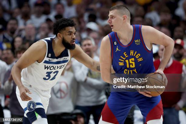Nikola Jokic of the Denver Nuggets is guarded by Karl-Anthony Towns of the Minnesota Timberwolves in the first quarter during Round 1 Game 1 of the...