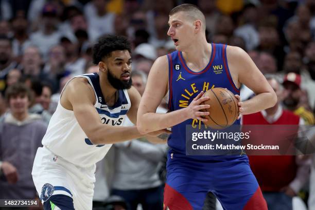 Nikola Jokic of the Denver Nuggets is guarded by Karl-Anthony Towns of the Minnesota Timberwolves in the first quarter during Round 1 Game 1 of the...