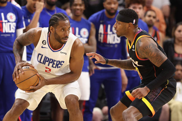Kawhi Leonard of the LA Clippers handles the ball against Torrey Craig of the Phoenix Suns during the second half Game One of the Western Conference...