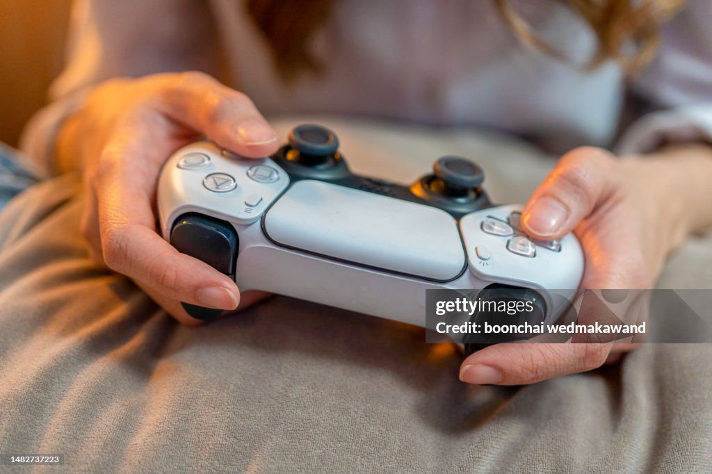 Hands with handheld game controls.