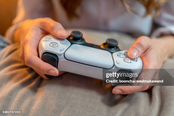 hands with handheld game controls. - playstation fotografías e imágenes de stock