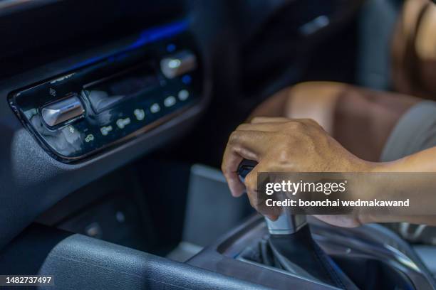 man's hand on automatic gearshift. - automatic gearshift stock pictures, royalty-free photos & images