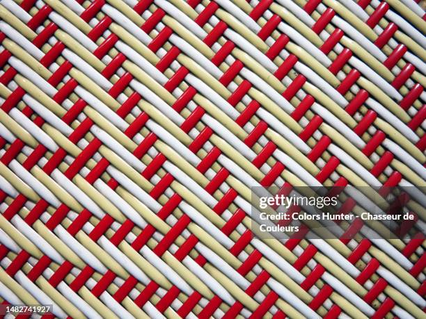 close-up of the red and white plastic braiding of the seat of a parisian bistro chair - terrasse de café stock-fotos und bilder