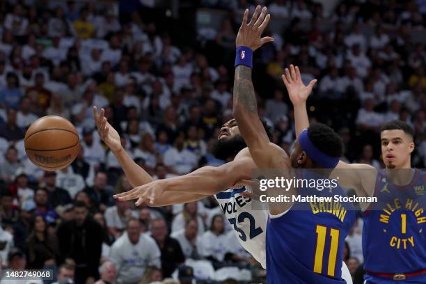 Karl-Anthony Towns of the Minnesota Timberwolves loses the ball while driving against Bruce Brown of the Denver Nuggets in the second quarter during...