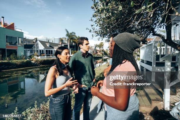 happiness multiracial friends talking outdoors in venice - la italia stock pictures, royalty-free photos & images