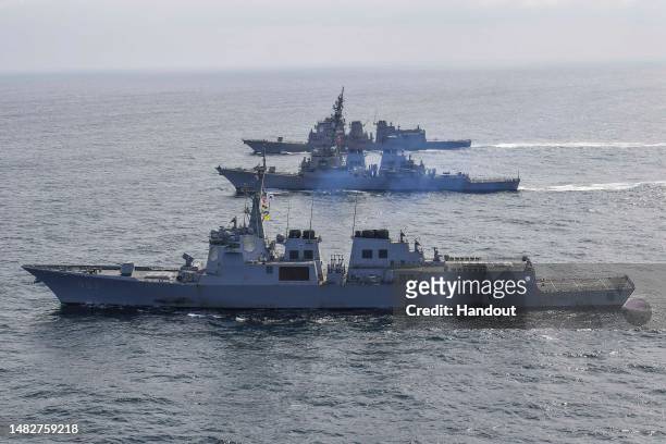 In this handout image released by the South Korean Defense Ministry, South Korean Navy's destroyer Yulgok Yi I , U.S. Navy's USS Benfold and Japan...