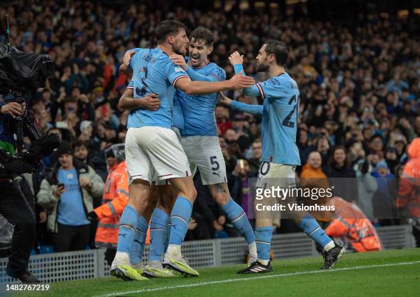 Rodrigo of Manchester City celebrates with team mates Ruben Dias, John Stones and Bernardo Silva after scoring during the UEFA Champions League...