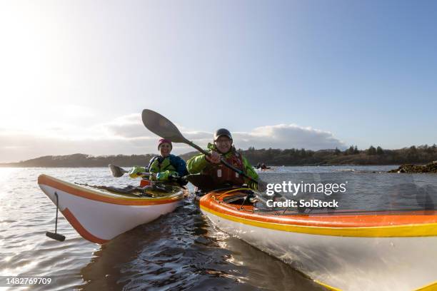 kayaking brings friends together - outdoor activity stock pictures, royalty-free photos & images