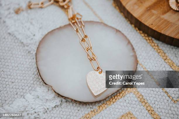 golden heart necklace jewelry on wooden surface.blogger.fashion - earrings stock pictures, royalty-free photos & images