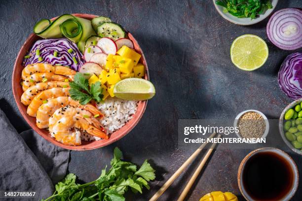 shrimp poke bowl on dark gray with mango, avocado, radish and carrot - shrimp edamame stock pictures, royalty-free photos & images