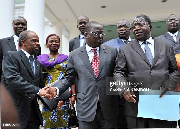 Ivory Coast's Prime Minister Jeannot Kouadio Ahoussou , speaks with Ivorian Popular Front party's interim president Sylvain Miaka Oureto after a...