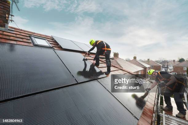 domestic solar panel installation - houses in the sun stock pictures, royalty-free photos & images