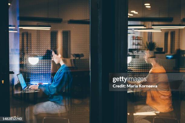 business people working at a co-working space in an isolated booth. - secrets stock pictures, royalty-free photos & images