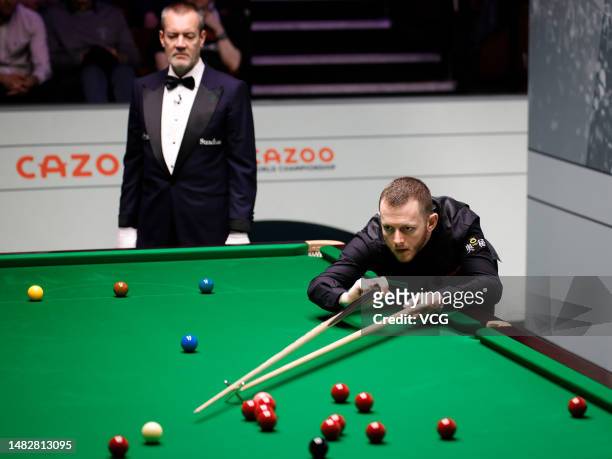 Mark Allen of Northern Ireland plays a shot in the first round match against Fan Zhengyi of China on day 3 of the 2023 Cazoo World Championship at...
