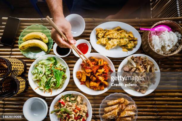 eating vietname lunch at bamboo table - vietnamese food stock pictures, royalty-free photos & images