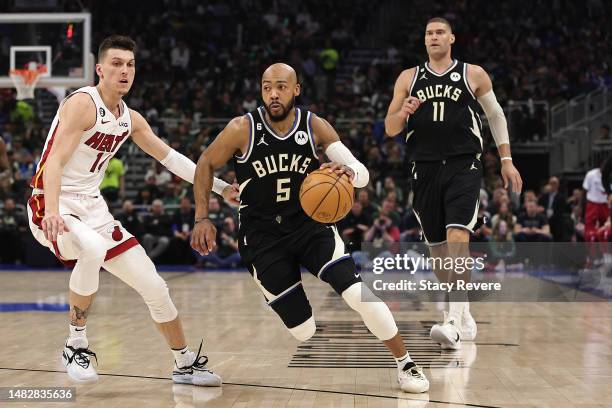 Jevon Carter of the Milwaukee Bucks drives around Tyler Herro of the Miami Heat during Game One of the Eastern Conference First Round Playoffs at...