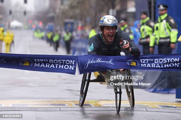 Marcel Hug of Switzerland crosses the finish line and takes first place in the professional Men's Wheelchair Division during the 127th Boston...