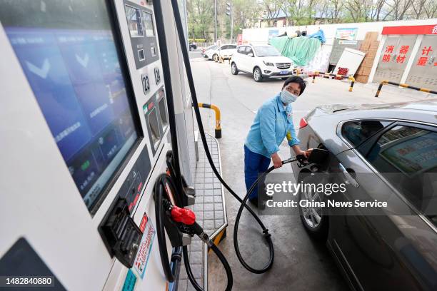 An employee refuels a car at a gas station of China National Petroleum Corporation on April 17, 2023 in Taiyuan, Shanxi Province of China.