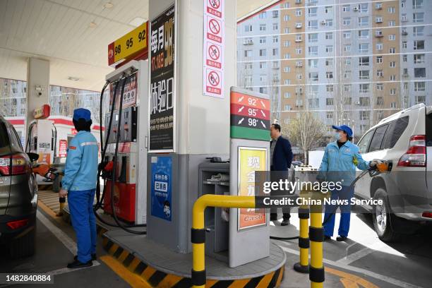 An employee refuels a car at a gas station of China National Petroleum Corporation on April 17, 2023 in Hohhot, Inner Mongolia Autonomous Region of...