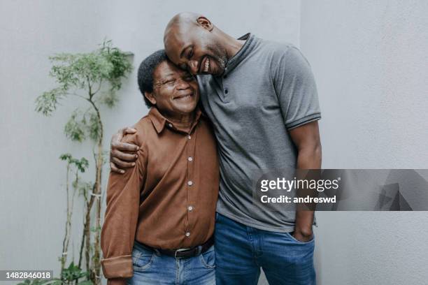 retrato de un padre mayor con un hijo adulto - old man afro fotografías e imágenes de stock